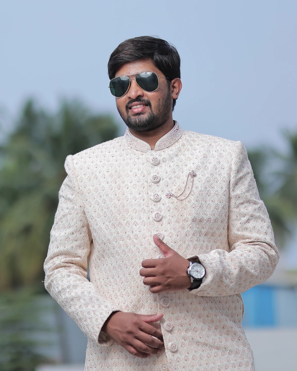 Man in a cream suit outdoors