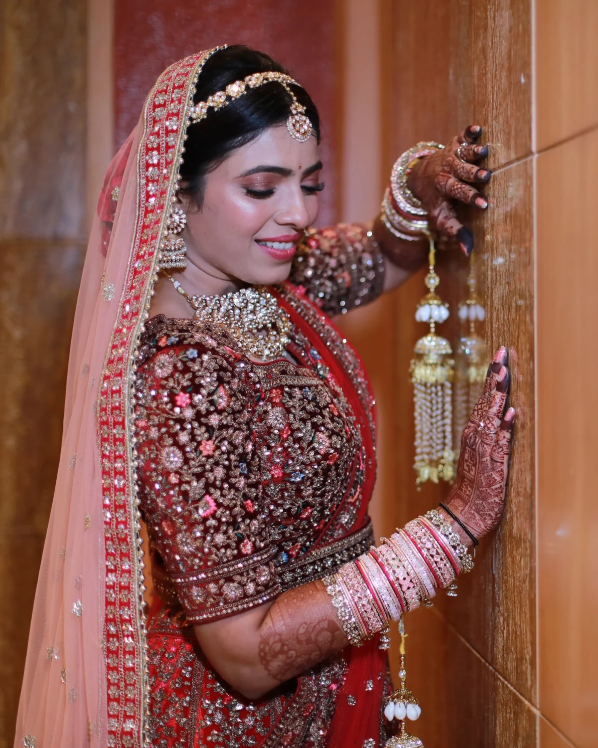 Bride posing beside a carved door